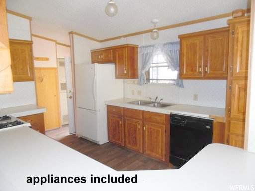 Kitchen featuring white fridge, sink, crown molding, black dishwasher, and dark hardwood / wood-style flooring