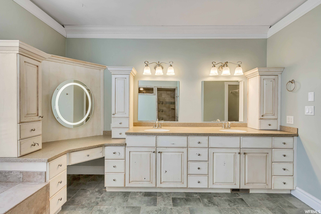 Bathroom with oversized vanity, double sink, and tile floors