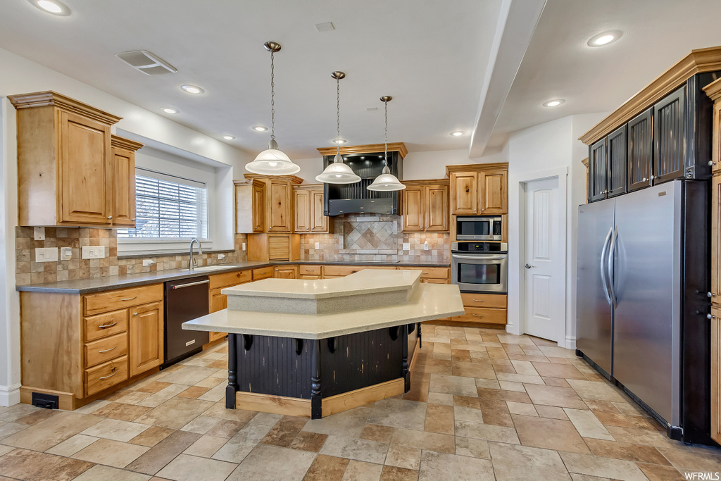 Kitchen featuring a center island, light tile floors, black appliances, decorative light fixtures, and backsplash
