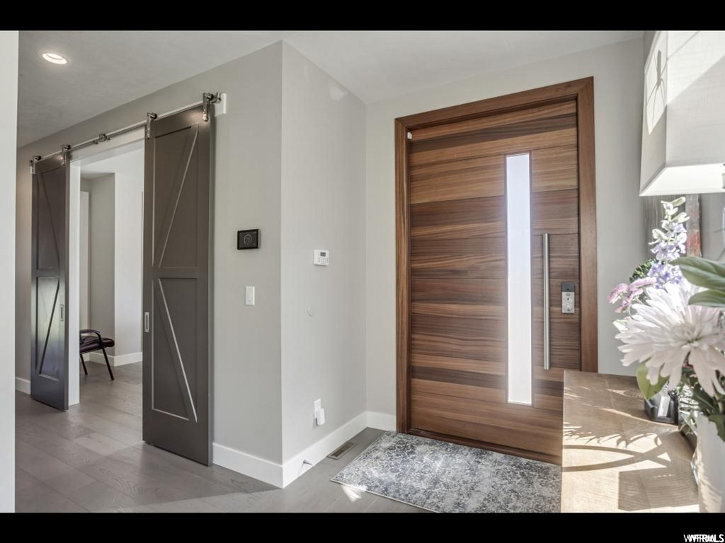 Foyer featuring light hardwood / wood-style flooring and a barn door