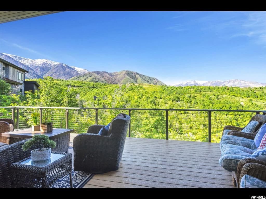 Deck with outdoor lounge area and a mountain view