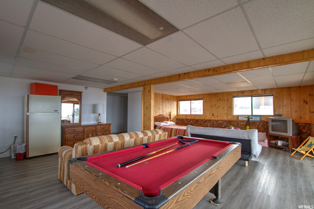 Playroom featuring dark wood-type flooring, a paneled ceiling, and pool table