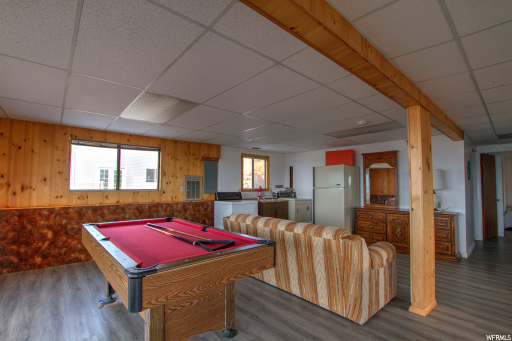 Playroom featuring dark hardwood / wood-style flooring, billiards, a paneled ceiling, and wooden walls