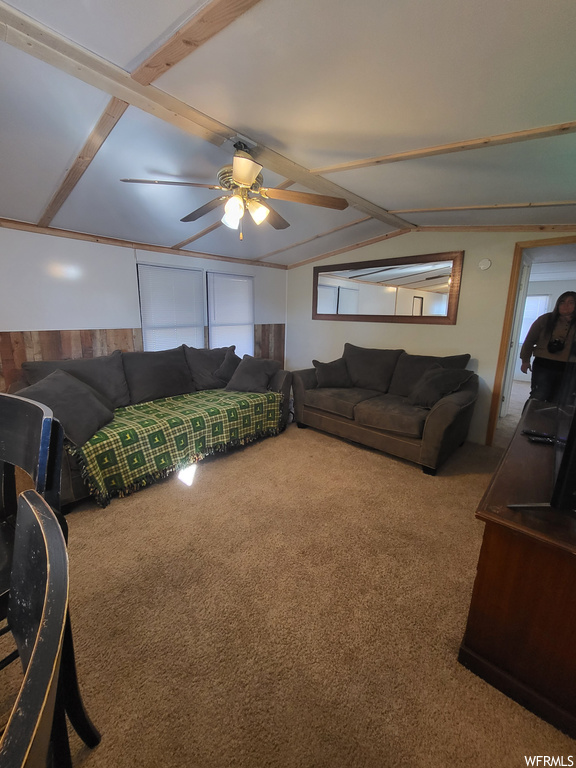 Living room featuring ceiling fan and light colored carpet