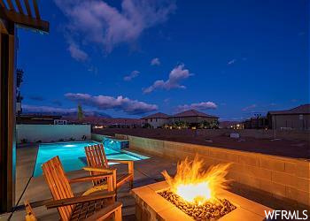 View of patio with an outdoor fire pit