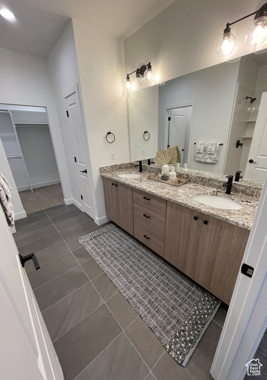 Bathroom featuring double vanity and tile floors