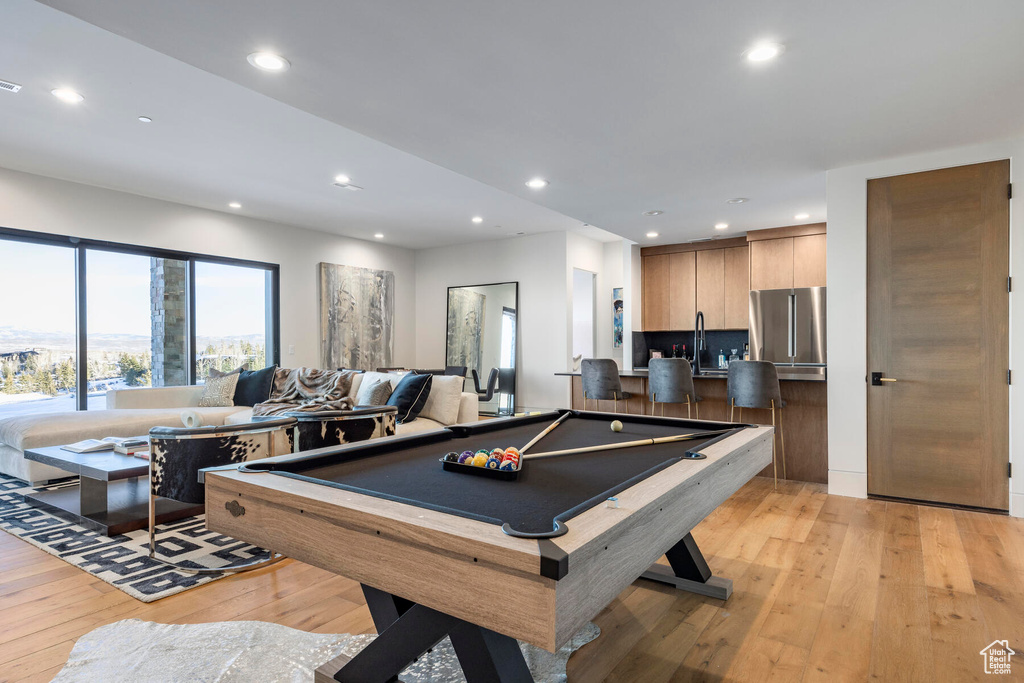 Recreation room featuring light hardwood / wood-style flooring and billiards
