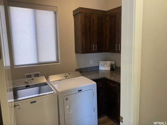 Laundry room with cabinets, hookup for a washing machine, and washer and dryer