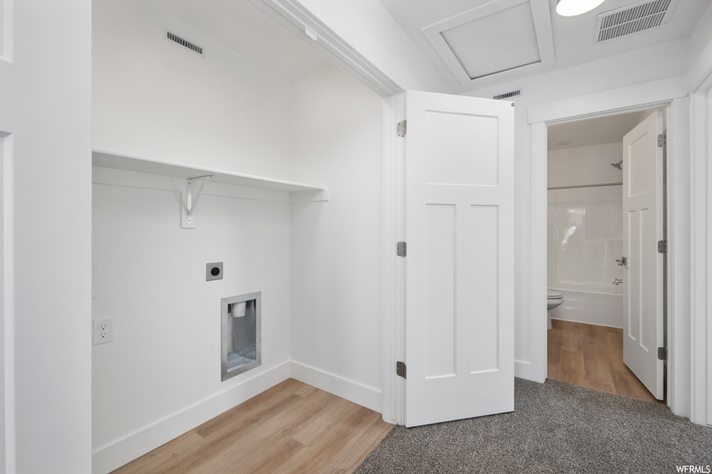 Washroom featuring hookup for an electric dryer and light hardwood / wood-style floors