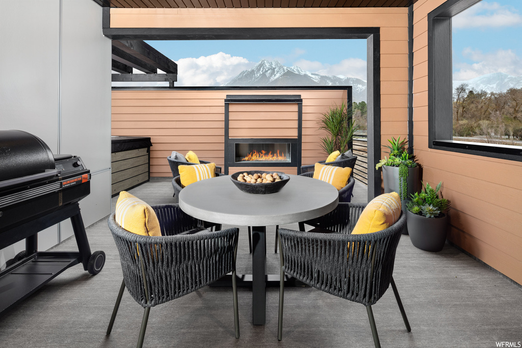 View of patio with area for grilling and a mountain view