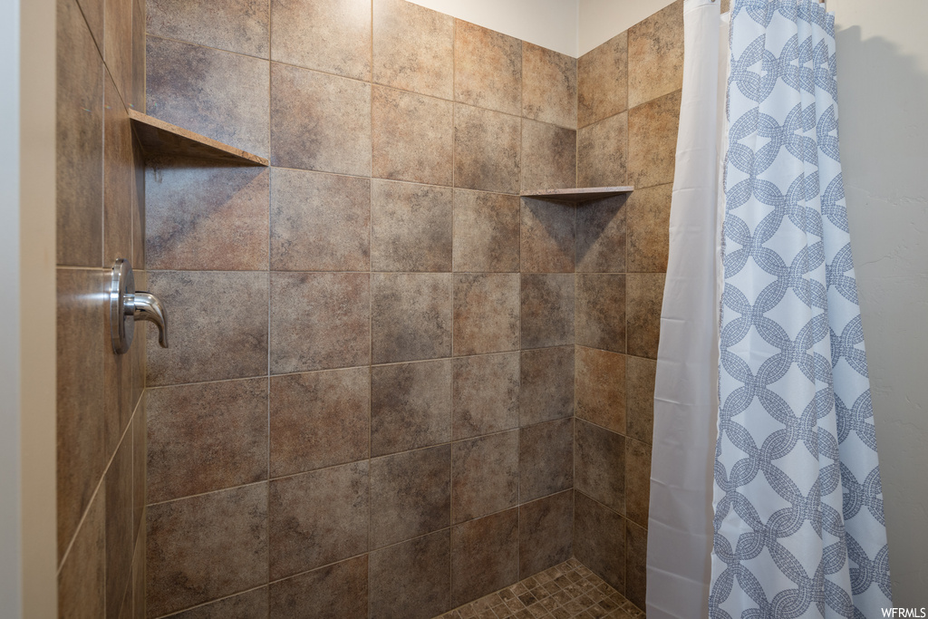 Bathroom featuring curtained shower