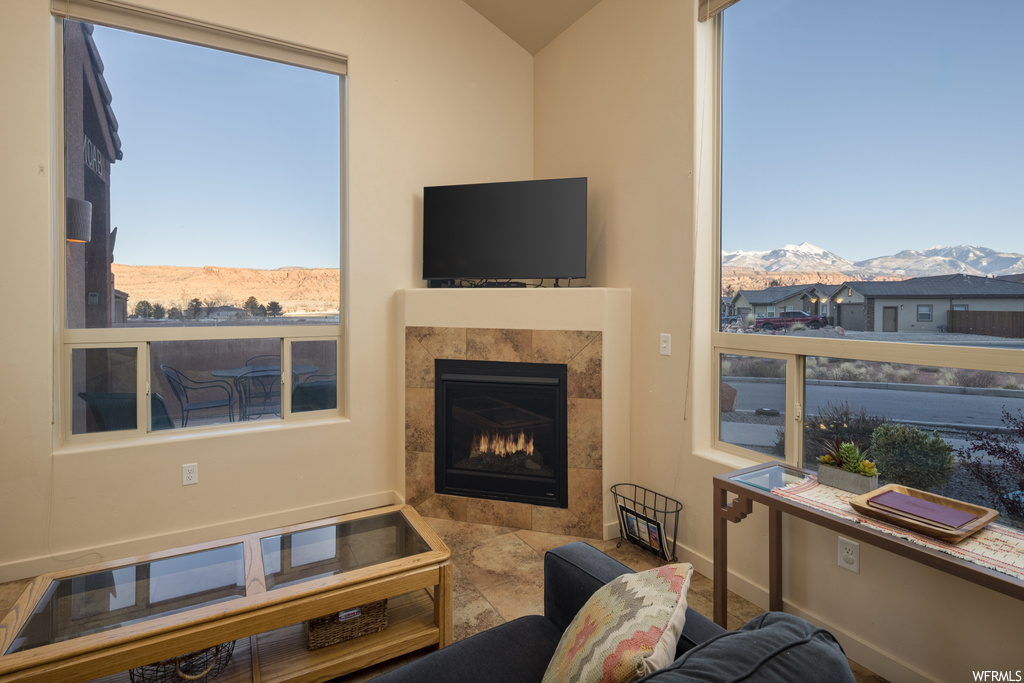 Tiled living room with a tiled fireplace and a mountain view