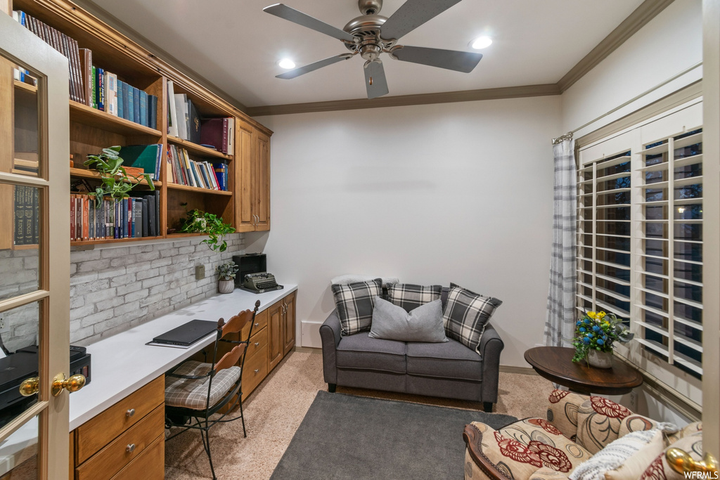 Carpeted home office featuring ornamental molding and ceiling fan