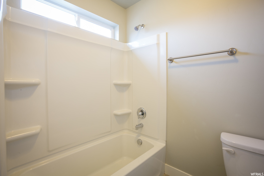 Bathroom featuring shower / bathtub combination and toilet