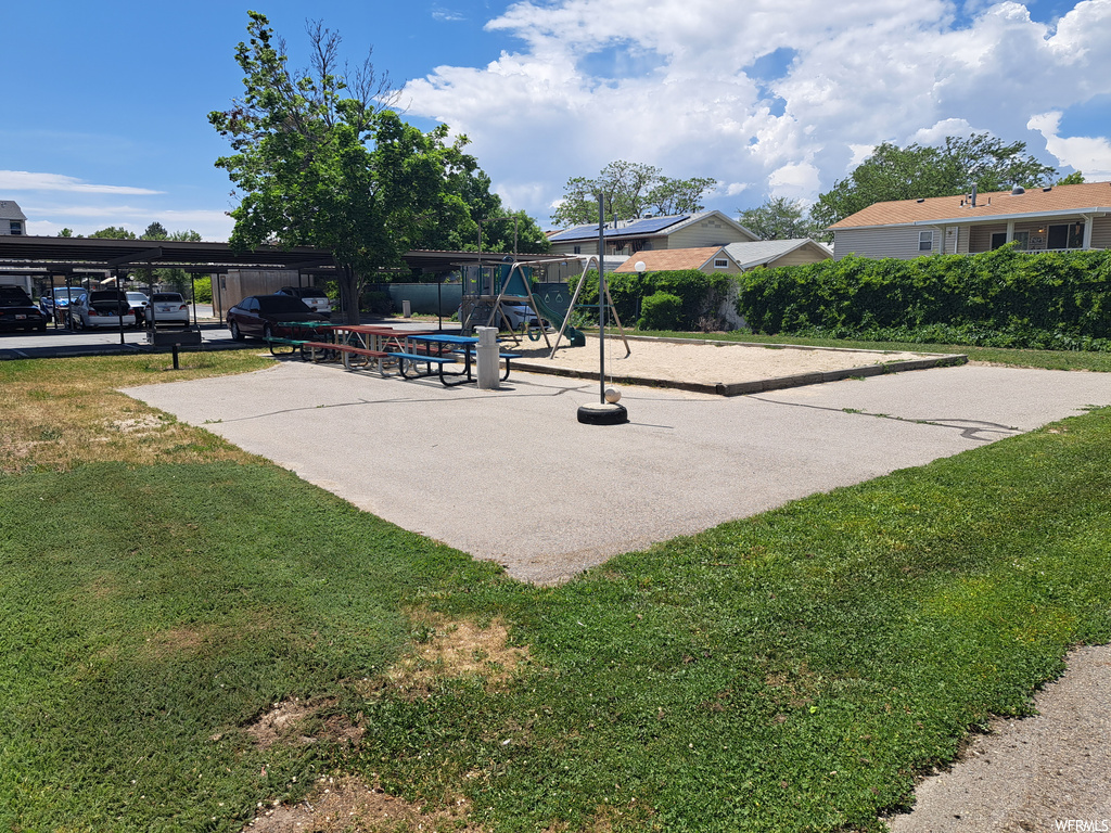 Surrounding community with a playground and a yard