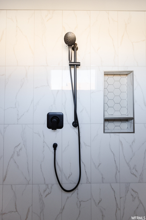 Room details with tiled shower