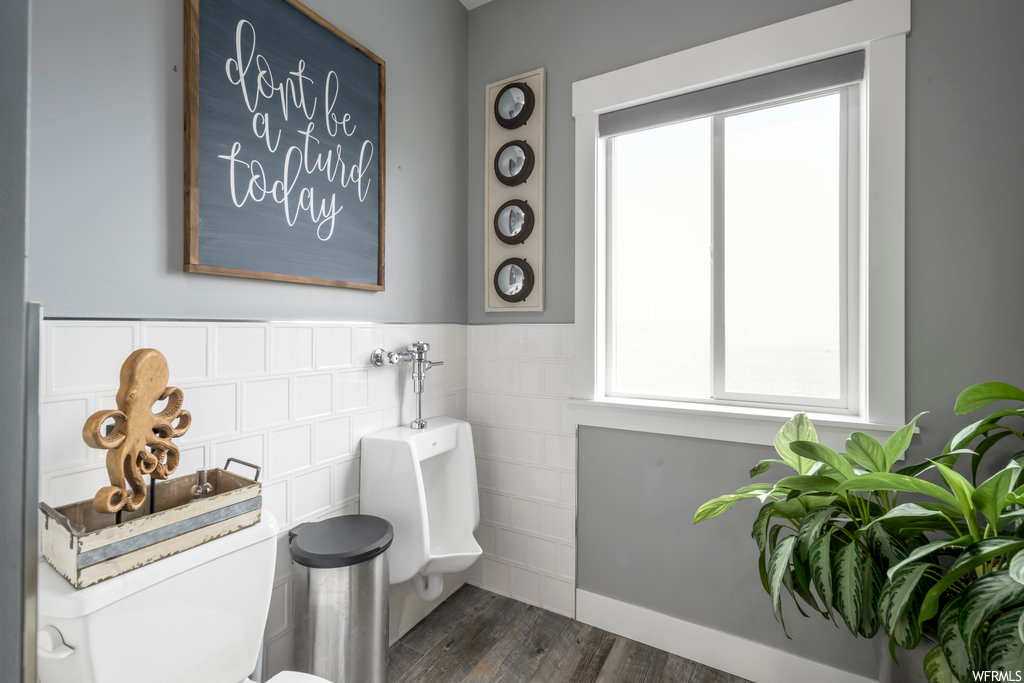 Bathroom featuring tile walls and hardwood / wood-style floors