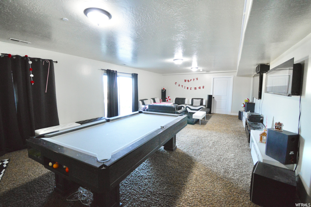 Recreation room with billiards, a textured ceiling, and carpet