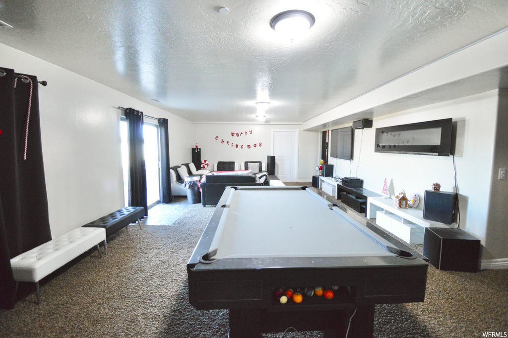 Rec room with billiards, a textured ceiling, and carpet