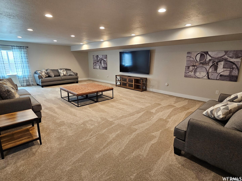 Living room with light carpet and a textured ceiling