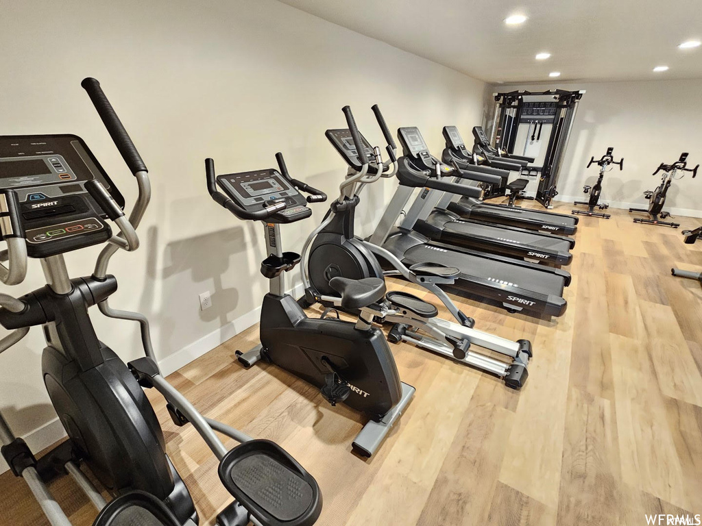 Exercise room with light wood-type flooring