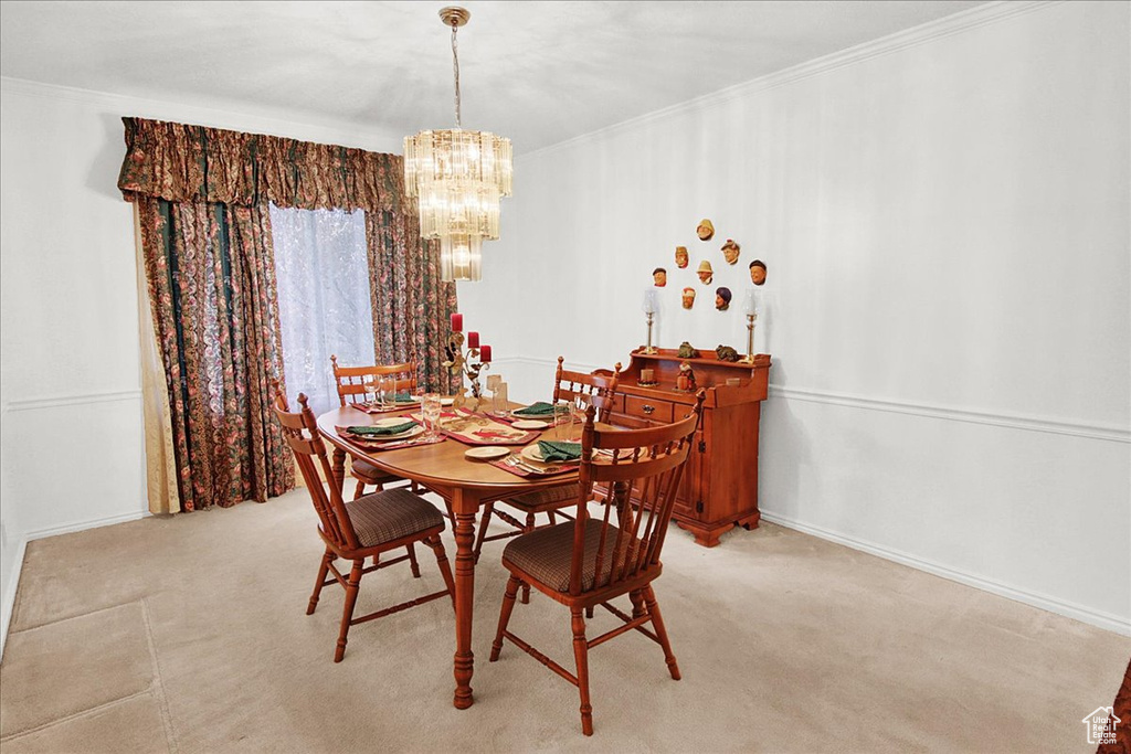 Dining area featuring a notable chandelier and crown molding