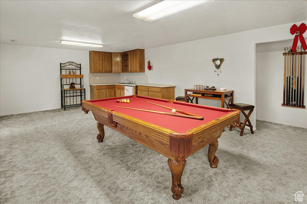 Recreation room featuring a textured ceiling, billiards, and light carpet