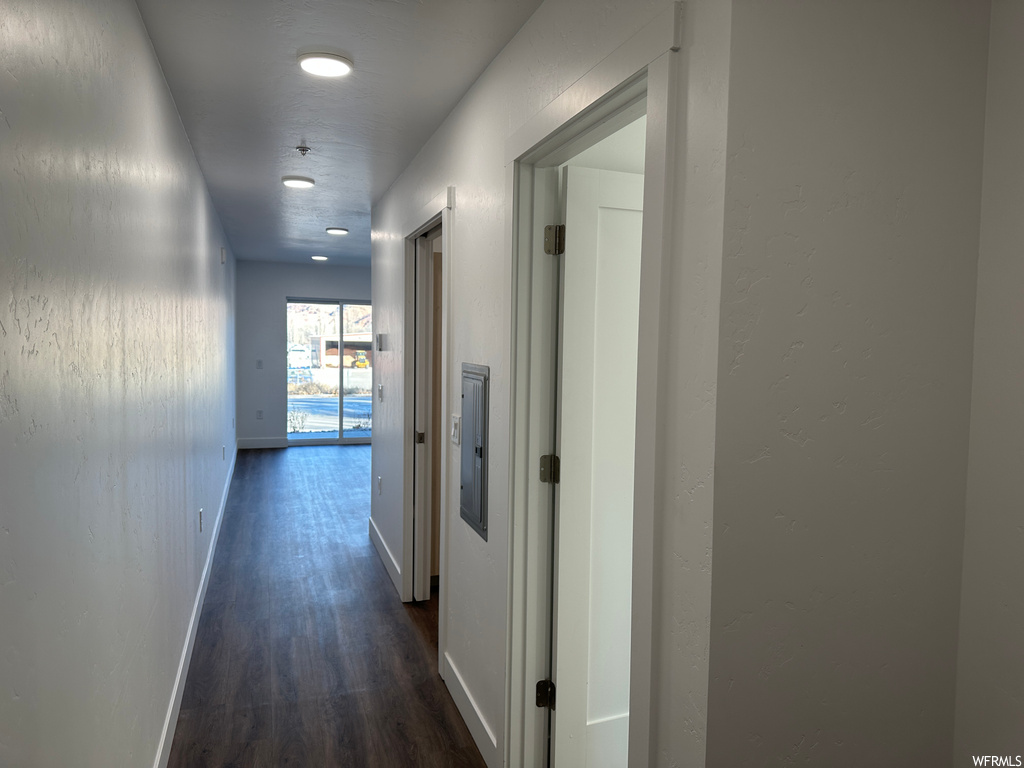 Corridor featuring dark hardwood / wood-style floors