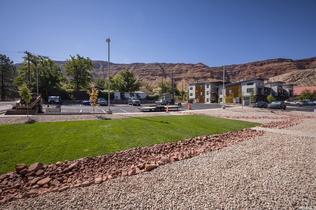 View of home\'s community featuring a yard and a mountain view