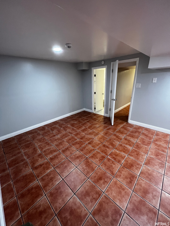 Basement featuring dark tile flooring