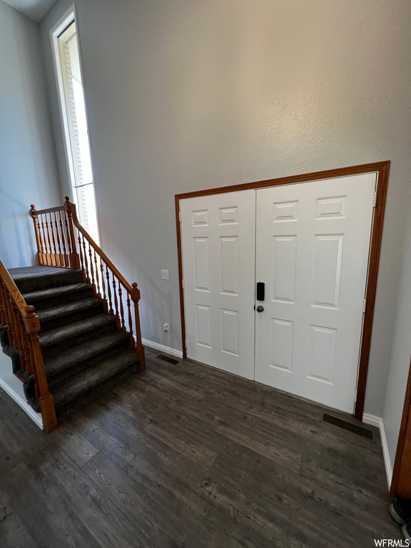 Entrance foyer with dark hardwood / wood-style floors and plenty of natural light