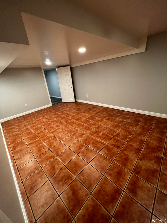 Empty room featuring dark tile floors