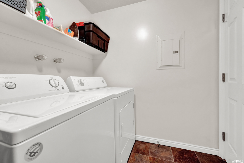 Washroom featuring dark tile flooring and independent washer and dryer