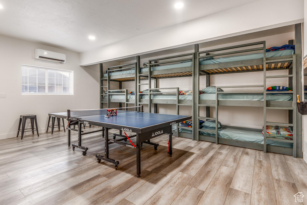 Rec room featuring light hardwood / wood-style floors and a wall mounted AC