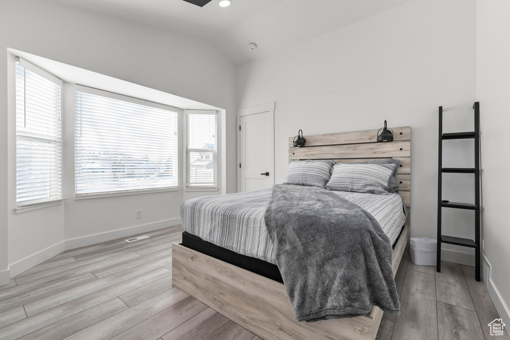 Bedroom featuring light hardwood / wood-style flooring and lofted ceiling