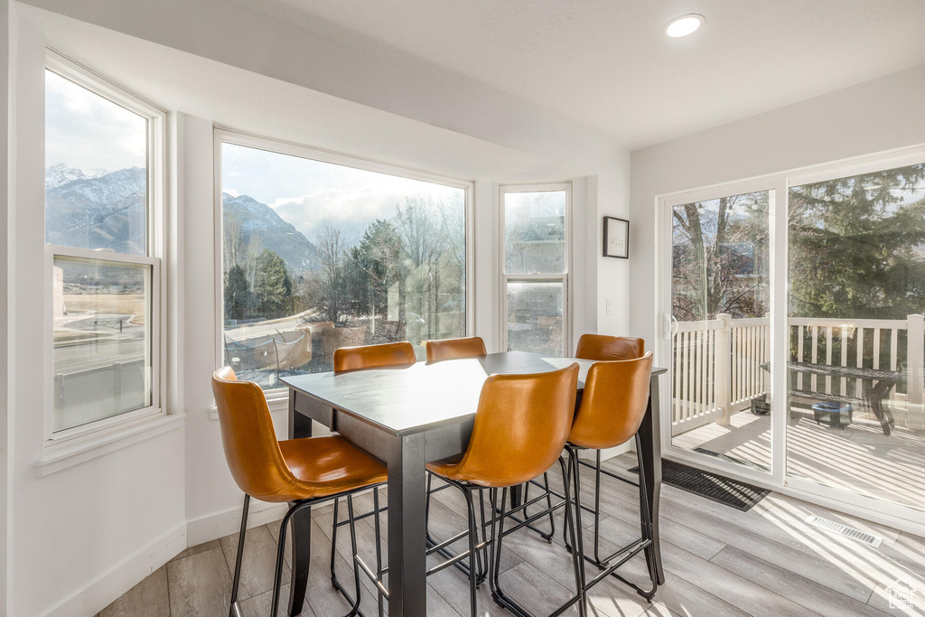 Dining space with light wood-type flooring and a mountain view