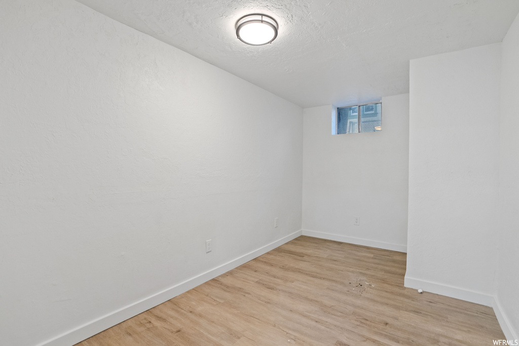 Spare room with light hardwood / wood-style flooring and a textured ceiling