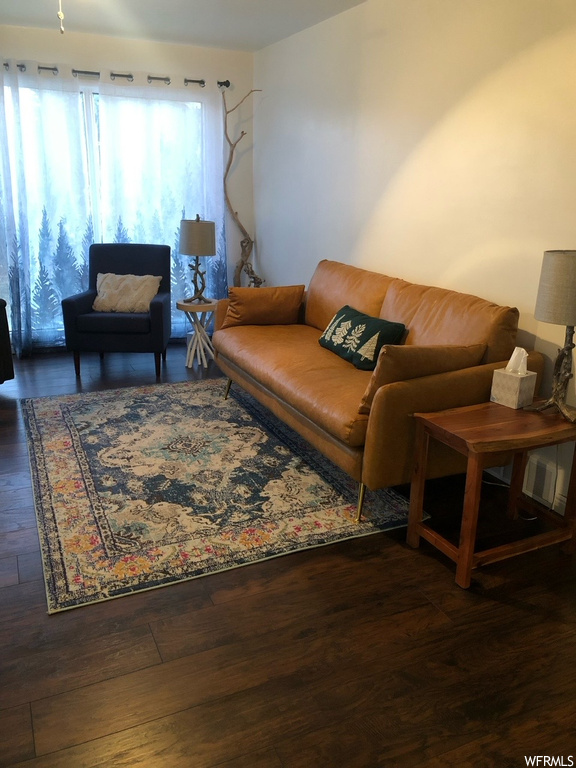 Living room with dark hardwood / wood-style floors