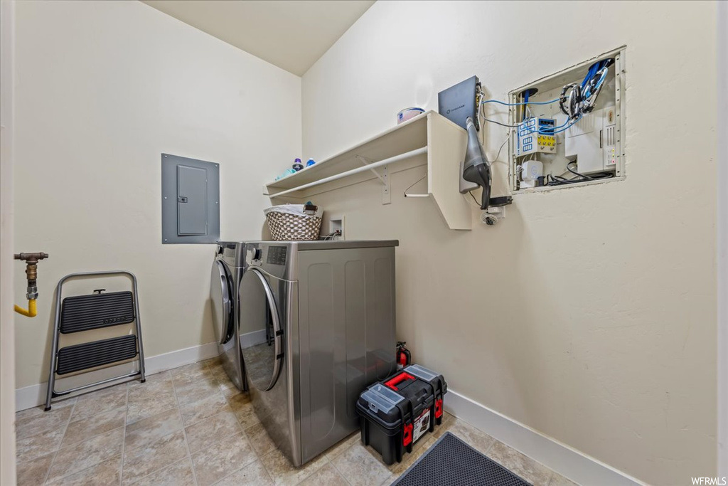 Laundry room featuring light tile flooring, separate washer and dryer, and hookup for a washing machine