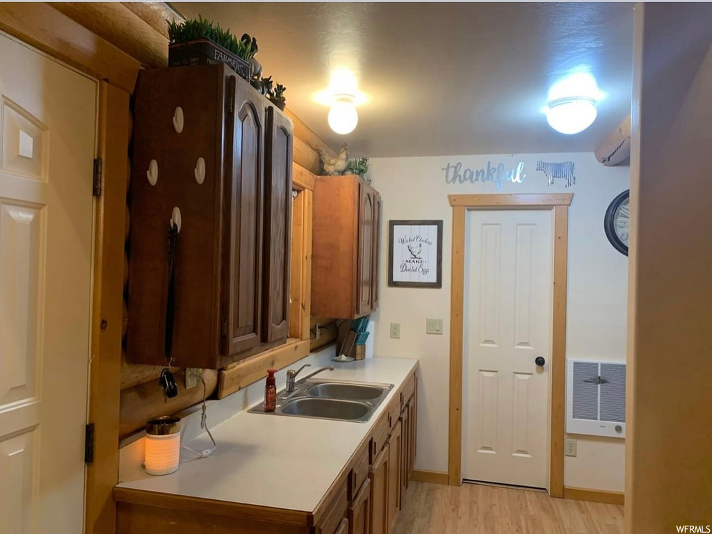 Kitchen featuring sink and light hardwood / wood-style flooring