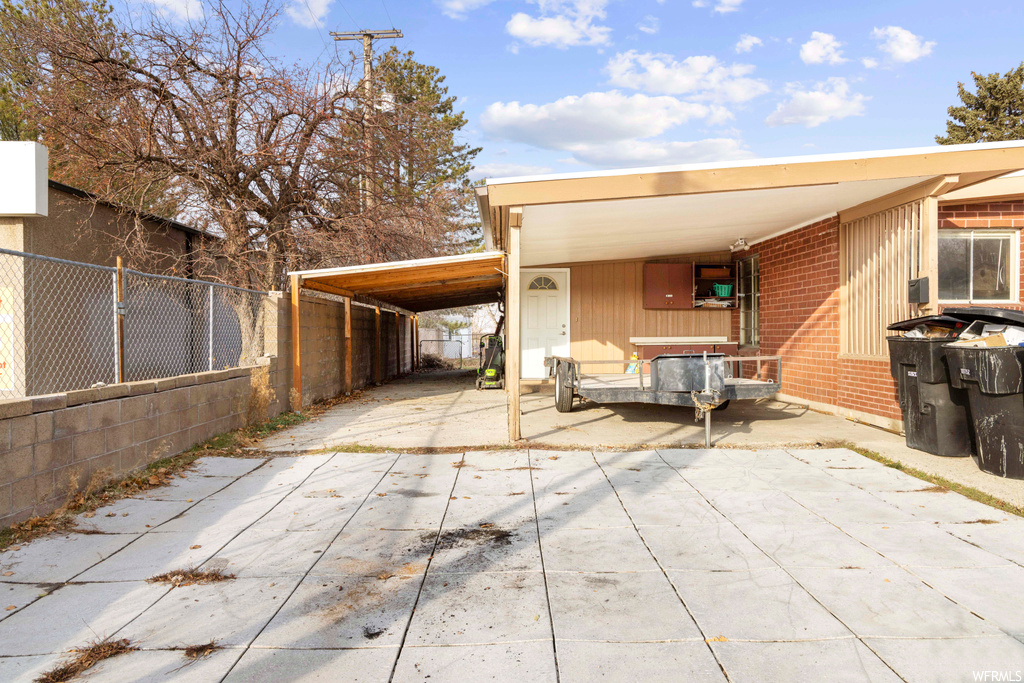 View of patio / terrace with a carport