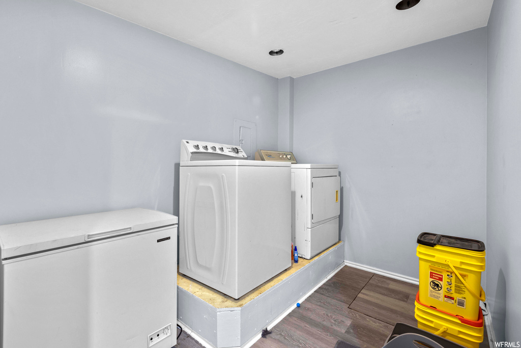 Laundry room featuring washing machine and dryer and dark hardwood / wood-style floors