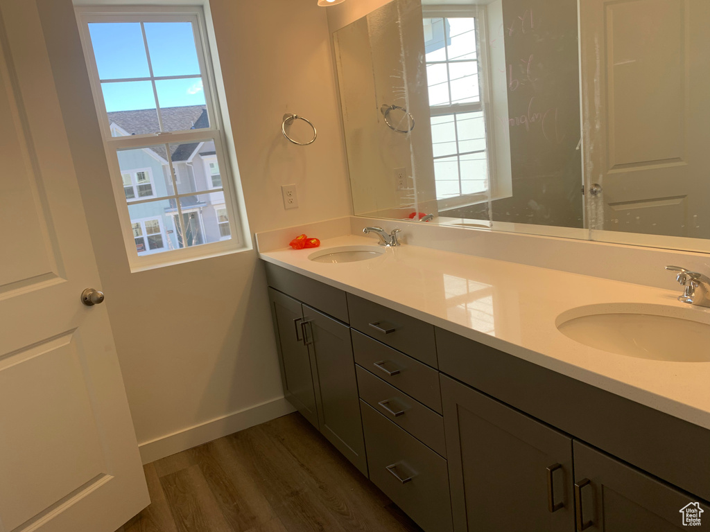Bathroom with hardwood / wood-style floors and double sink vanity