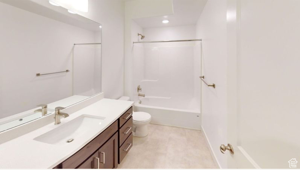 Full bathroom featuring shower / washtub combination, toilet, and large vanity