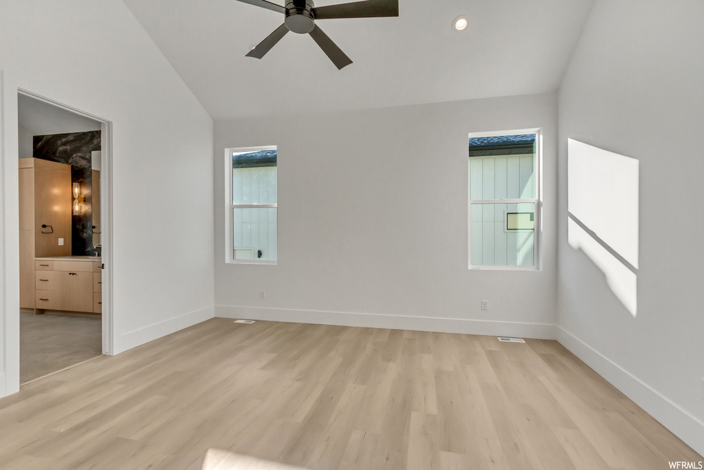 Empty room with plenty of natural light, ceiling fan, and light hardwood / wood-style flooring