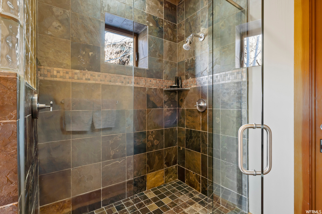 Bathroom with a shower with door and plenty of natural light