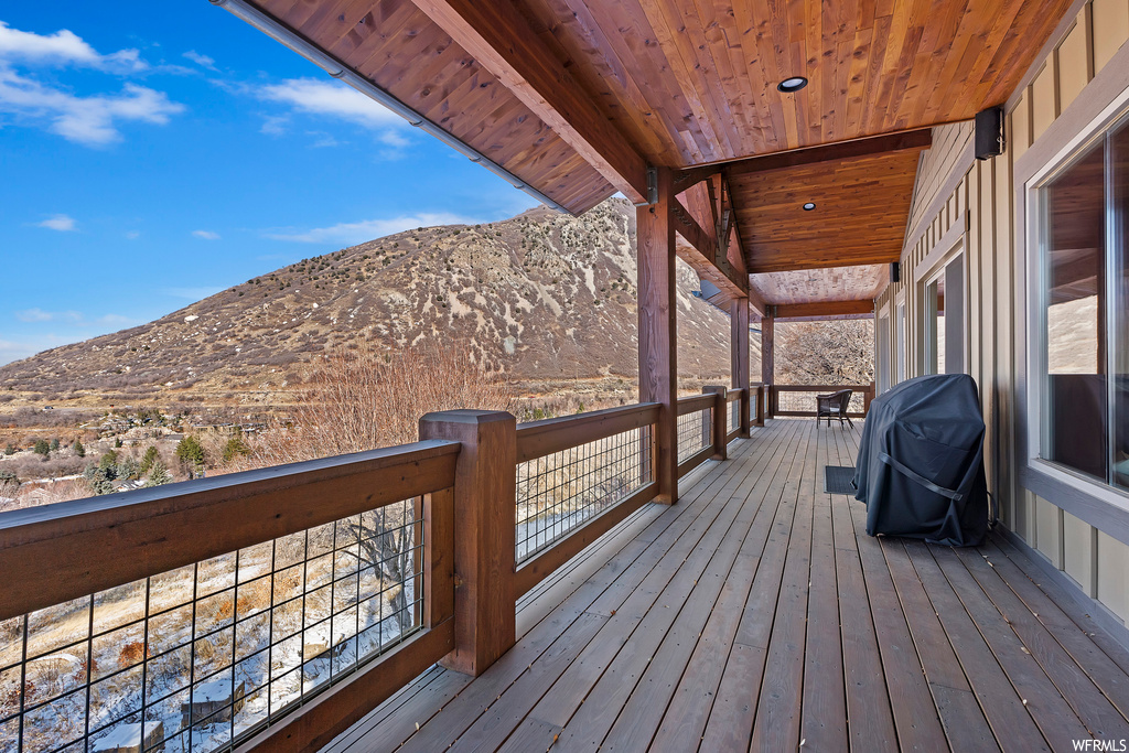 Wooden terrace with a grill and a mountain view