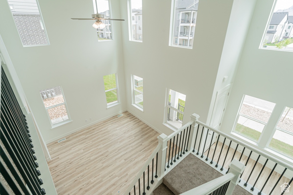 Stairway featuring plenty of natural light and a high ceiling