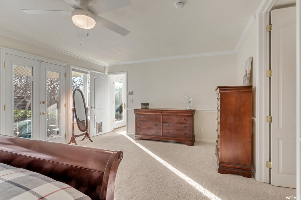 Carpeted bedroom featuring french doors, access to exterior, ceiling fan, and ornamental molding