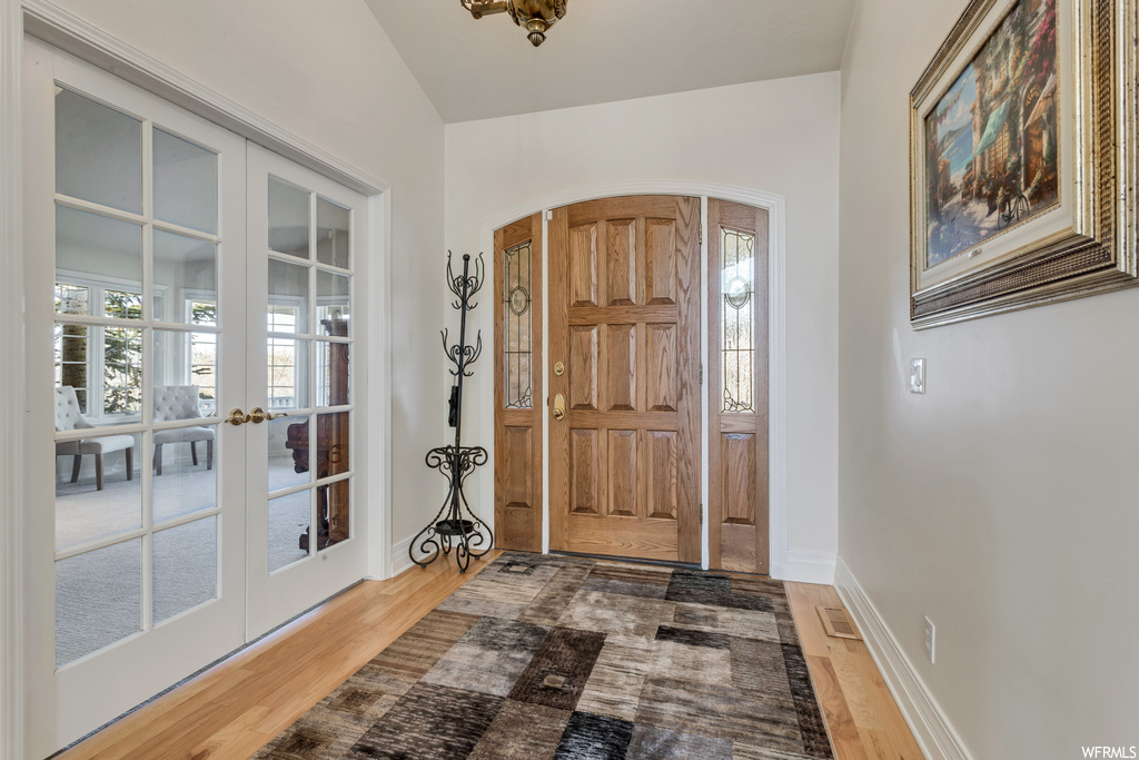 Entrance foyer featuring dark hardwood / wood-style floors and french doors